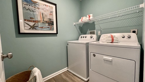 The laundry room includes a washer and dryer.