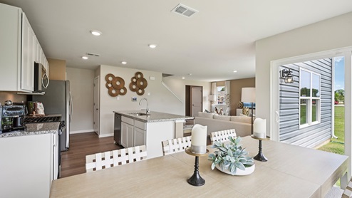 The kitchen has a designated dining area with a sliding glass door for easy access to the backyard.