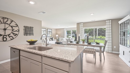 The kitchen is open to the informal dining area that leads to the back sliding door.