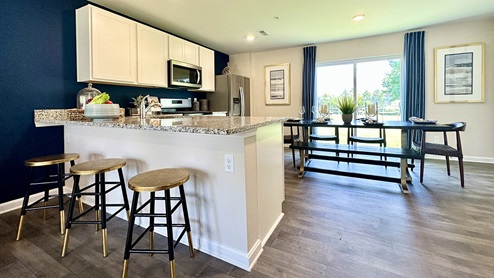 The functional kitchen offers a peninsula island overlooking the family room.