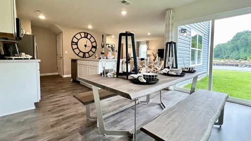 The kitchen has a designated dining area with a sliding glass door for easy access to the backyard.
