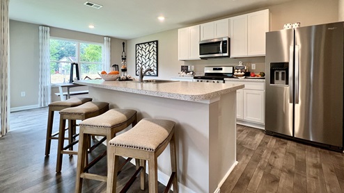 The spacious kitchen has a large island with room for seating.