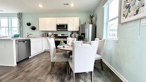 The kitchen includes stainless steel appliances.
