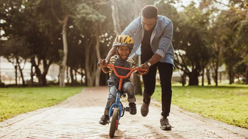 father son riding bike