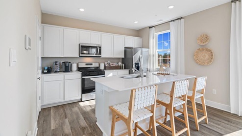 spacious open concept kitchen with island with seating