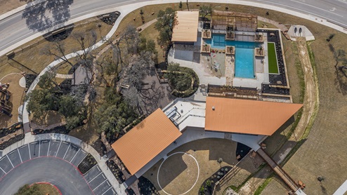 Bulverde Texas DR Horton Homes Copper Canyon New Construction Homes aerial view of Copper Canyon amenity center walk trail community center gym outdoor kitchen splashpad pool covered pavilion and playground