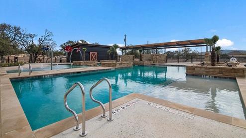 Bulverde Texas DR Horton Homes Copper Canyon New Construction Homes outdoor pool with beach entry splashpad with water features and covered pavilion