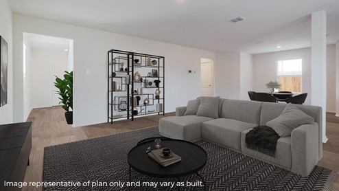 DR Horton San Antonio Laurel Vistas the ingleside floor plan 1900 square feet living room with virtually stage sectional couch, area rug, circular coffee table and large plant holder