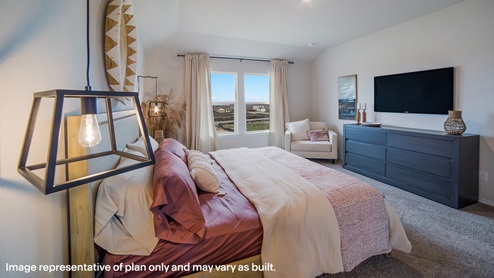 DR Horton San Antonio Laurel Vistas the kate 2223 square feet main bedroom suite with carpet flooring, king sized bed, side tables, dressers, overstuffed armchair and large windows for natural lighting