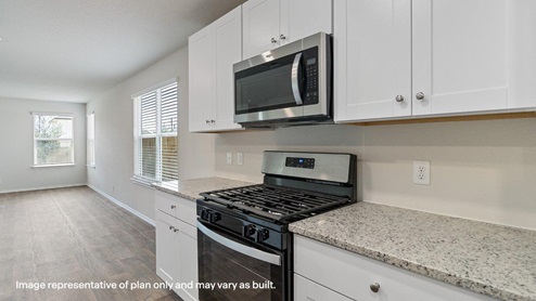 kitchen with stainless steel appliances, abundant cabinets and counterspace