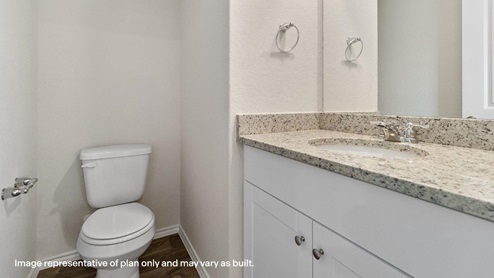 downstairs powder bathroom with toilet and single vanity sink