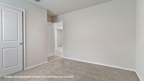 third bedroom with carpet flooring and closet