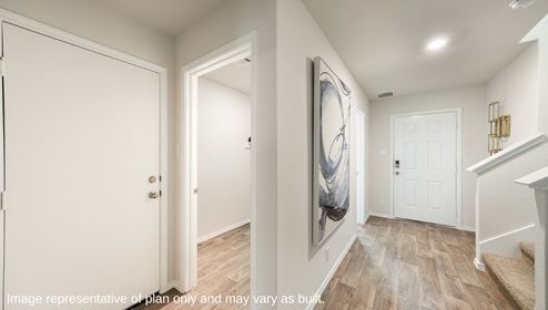 Entryway leading into powder bathroom and living area.