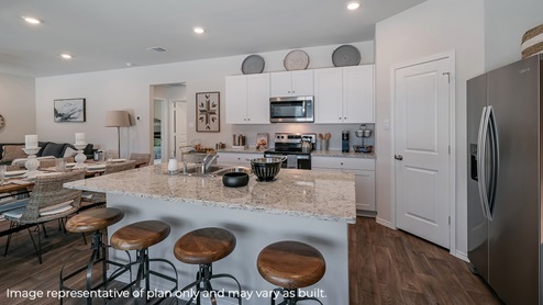 DR Horton Von Ormy Preserve at Medina the diana floor plan 1535 square feet kitchen with large kitchen island and bar stools white cabinets and stainless steel appliances
