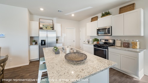 DR Horton Von Ormy Preserve at Medina the hanna floor plan 2042 square feet kitchen with white cabinets stainless steel appliances granite countertops and spacious kitchen island with sink