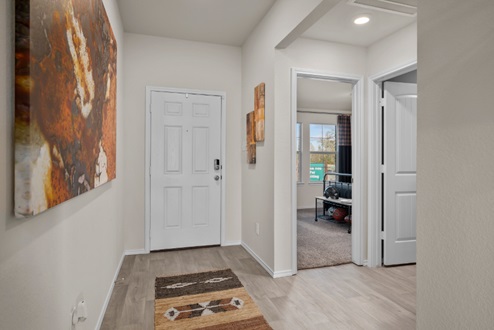 Rockbridge Model Home entr with vinyl plank flooring and view to secondary bedrooms.