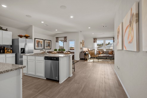 Rockbridge Model Home open-concept kitchen with white cabinetry and view to living room.