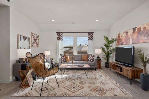 Rockbridge Model Home open-concept living room with gray sofas and windows to backyard.