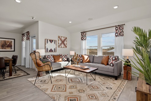 Rockbridge Model Home open-concept living room with furniture, windows, and vinyl plank flooring.