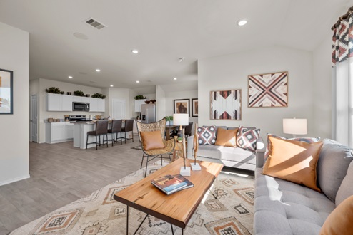 Rockbridge Model Home furnished open-concept living room with view to kitchen.