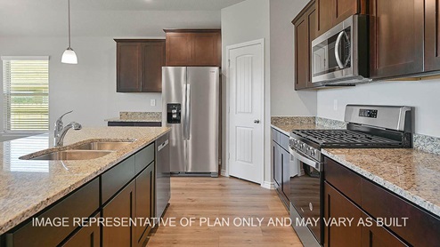 Dakota kitchen with dark stained cabinetry, granite countertops, kitchen island, and vinyl plank flooring.