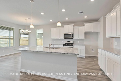 Sonoma kitchen with white cabinets, granite countertops and vinyl plank flooring.