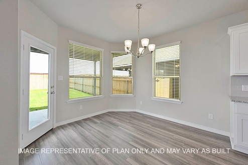 Sonoma dining room with bay windows and vinyl plank flooring.