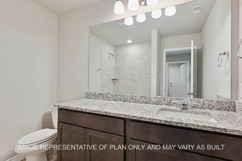 Richmond secondary bathroom with dark cabinets, granite countertops, ceramic tile shower surround and vinyl plank flooring.