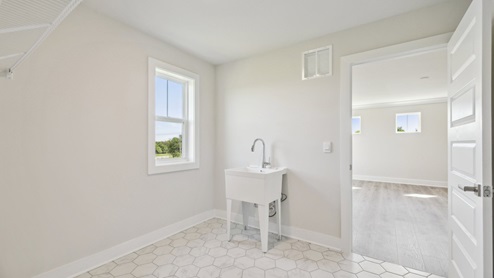 Laundry room comes with a sink and two entrances