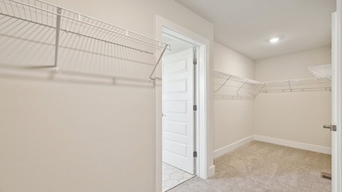 Primary bedroom closet connects to laundry room