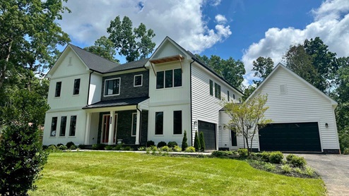 An estate home sitting on a 10-acre homesite in Nokesville, VA featuring white siding
