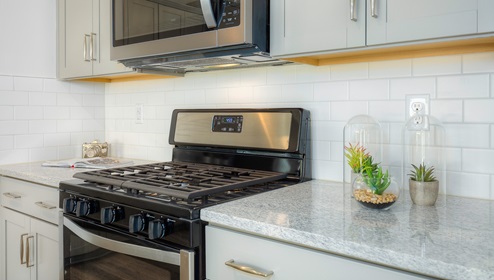 Kitchen and island, wood floor, white cabinets