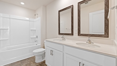 Bathroom with double sink vanity and bathtub and shower combination. New home in Asheville, North Carolina