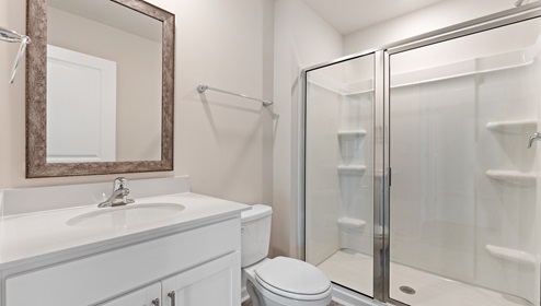 Bathroom with standing glass door shower. New home in Asheville, North Carolina