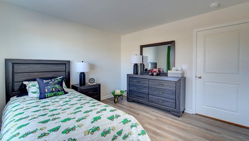 bedroom with vinyl floors and large window