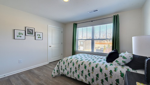 bedroom with vinyl floors and large window