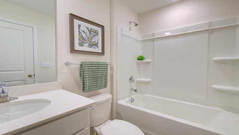 bathroom with white cabinets, and bathtub shower combination