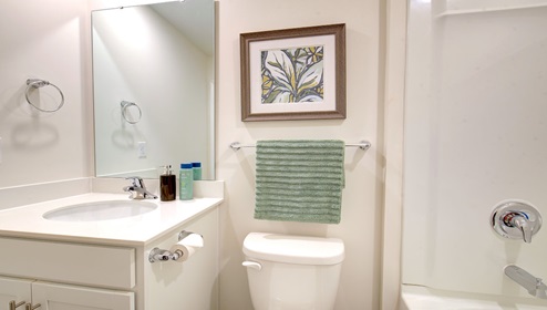 bathroom with white cabinets, and bathtub shower combination