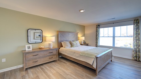 bedroom with vinyl floors and large window