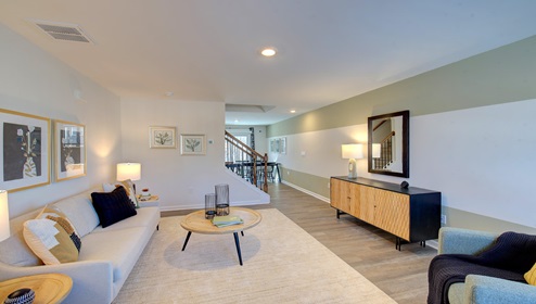family room beside foyer and staircase with large window
