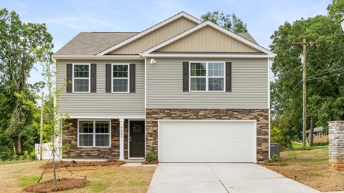 Rosewood Village Penwell Model front exterior with beige siding, stone, and two car garage