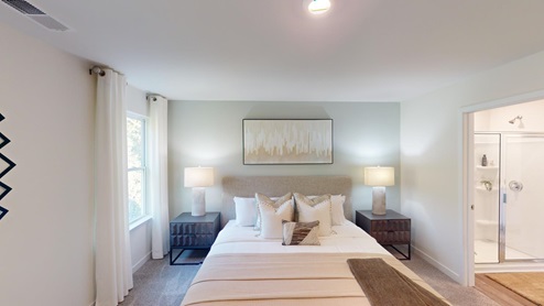 Primary bedroom with carpet and large windows
