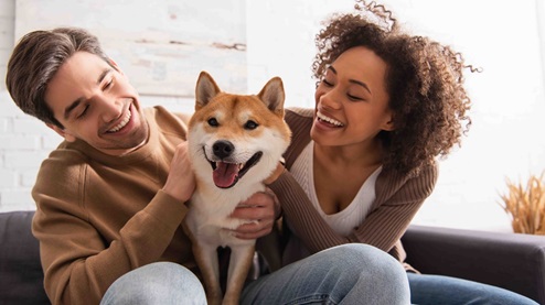 couple with dog in new home