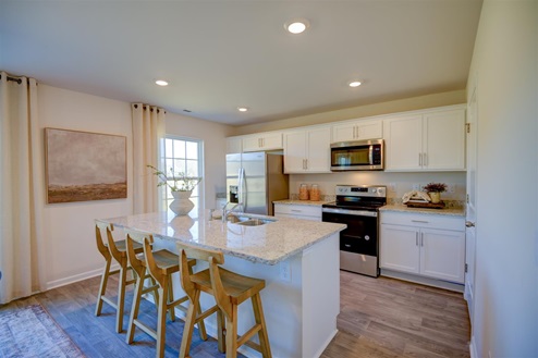 kitchen with vinyl floors an island and stainless steel appliances