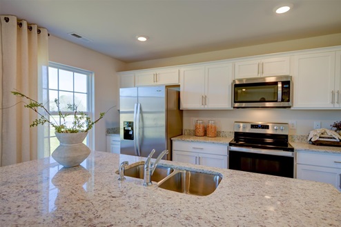 kitchen with vinyl floors an island and stainless steel appliances