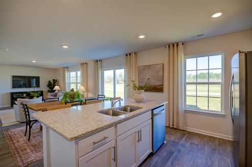 kitchen with vinyl floors an island and stainless steel appliances