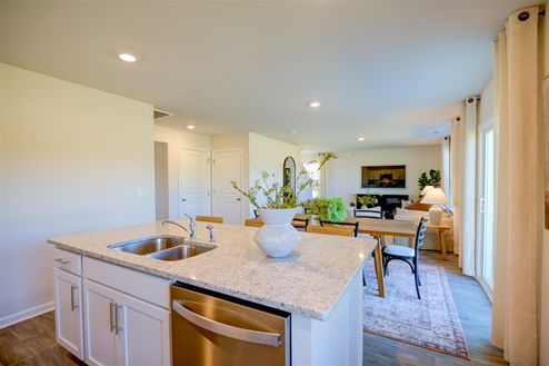 kitchen with vinyl floors an island and stainless steel appliances