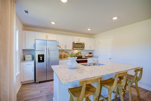 kitchen with vinyl floors an island and stainless steel appliances