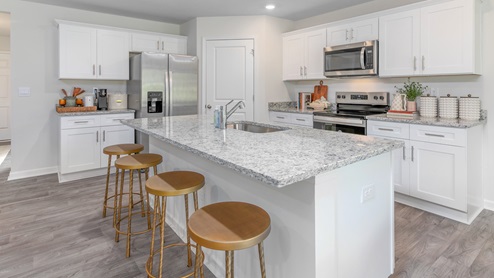 kitchen island with white cabinets and seating for 4
