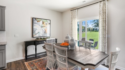 Dining area with ample lighting and revwood flooring
